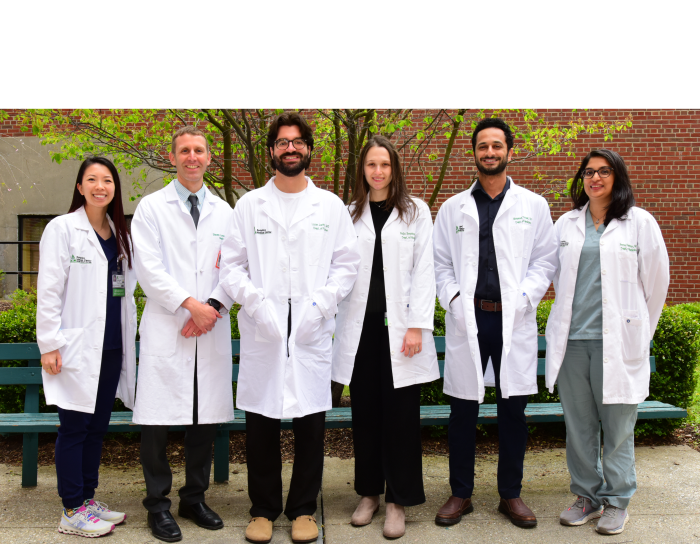 A photograph of a group of five medical residents with Dr Lamontagne, Program Director