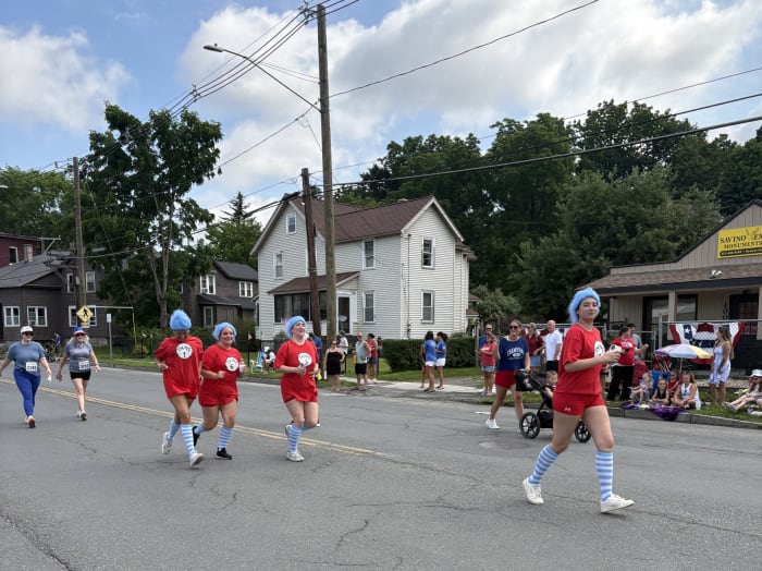 A photo of Things 1 through 4 running in the BHS 4th of July 5k