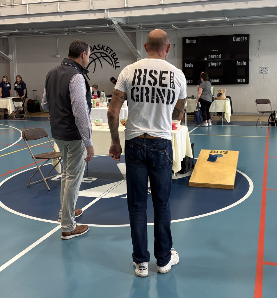 Photo of a community member playing baggo with a Berkshire Health System Provider